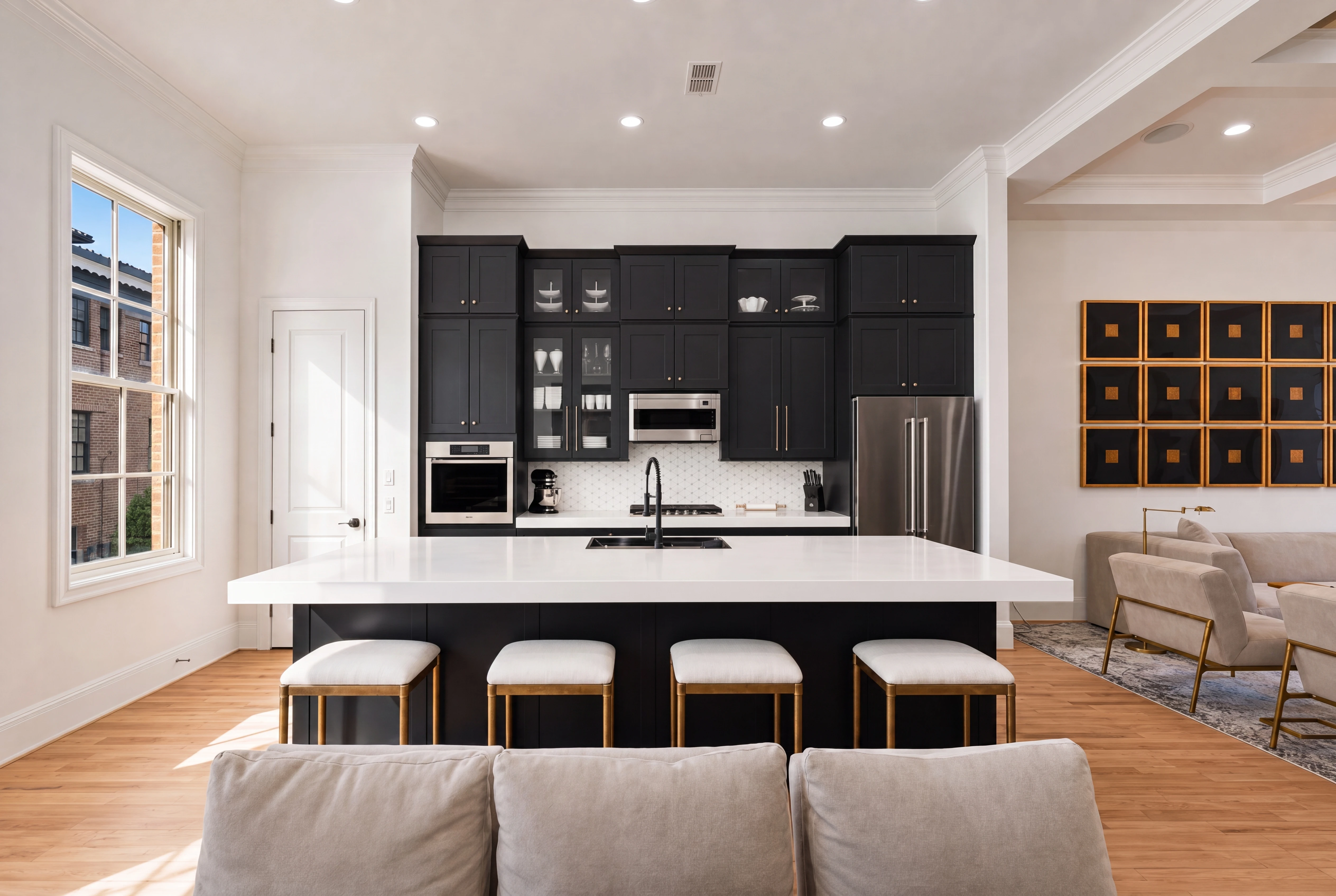Gourmet kitchen with charcoal cabinetry and quartz waterfall island